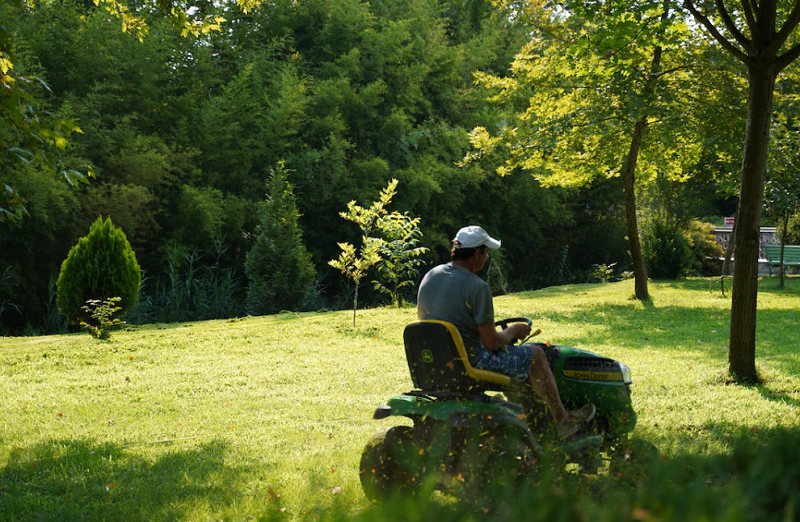 man mowing the green lawn